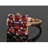 9 carat gold and garnet ring, forming a flower head