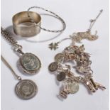 Mixed lot of silver jewellery to include, a silver charm bracelet, a silver bangle, a silver coin