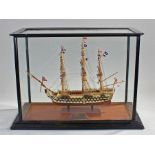 Cased model of H.M.S. Victory, the ship raised on columns housed within a glass case, the case