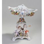 Capodimonte porcelain table centre piece, the basket above putti, N mark above a crown to the