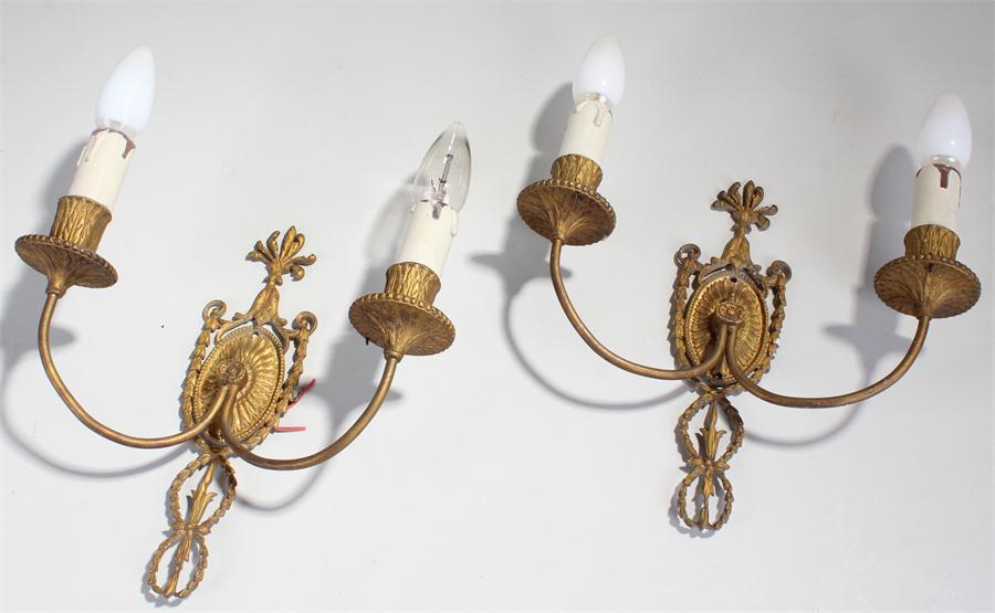 Two gilt metal wall lights with swag ribbon decoration