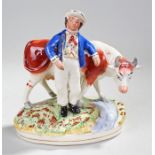 19th Century Staffordshire figure, of a man and cow, 22cm high