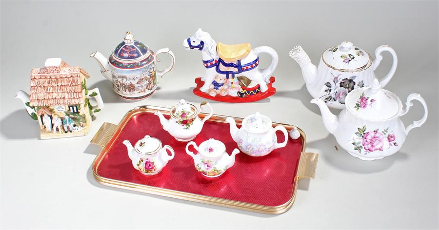 Seven novelty teapots to include a cricket related one and rocking horse. (7)