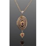 15 carat gold locket pendant on chain, the oval locket set with an oval faceted amethyst within a