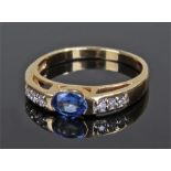 18 carat gold sapphire and diamond ring, the oval sapphire flanked by three diamonds to either