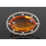 Fire opal and diamond brooch, the fire opal at 17.25 carats surrounded by diamond set to circular