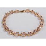 9 carat gold, stone set bracelet, the bracelet set with pink stones to link ends, 18.5cm long