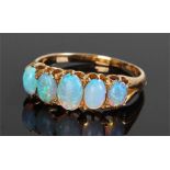 18 carat gold and opal set ring, with a row of five opals, ring size Q