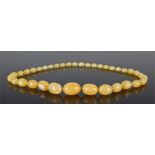 Yellow composite amber necklace, with graduated beads, the largest 28mm wide