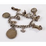 Silver charm bracelet, set with various charms, 58.7 grams