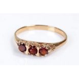 9 carat gold ring, set with red stones