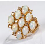 18 carat gold opal and diamond set ring, the head set with nine opals and twelve diamonds, ring size