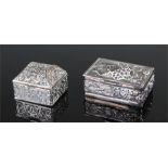 Two white metal boxes, with embossed decoration, 38mm & 26mm wide, (2)