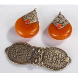 Pair of Middle Eastern amber type earrings, with white metal mounts, together with white metal