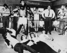 ALI, MUHAMMAD - Black and white photograph of the Beatles pretending to cower...  Black and white
