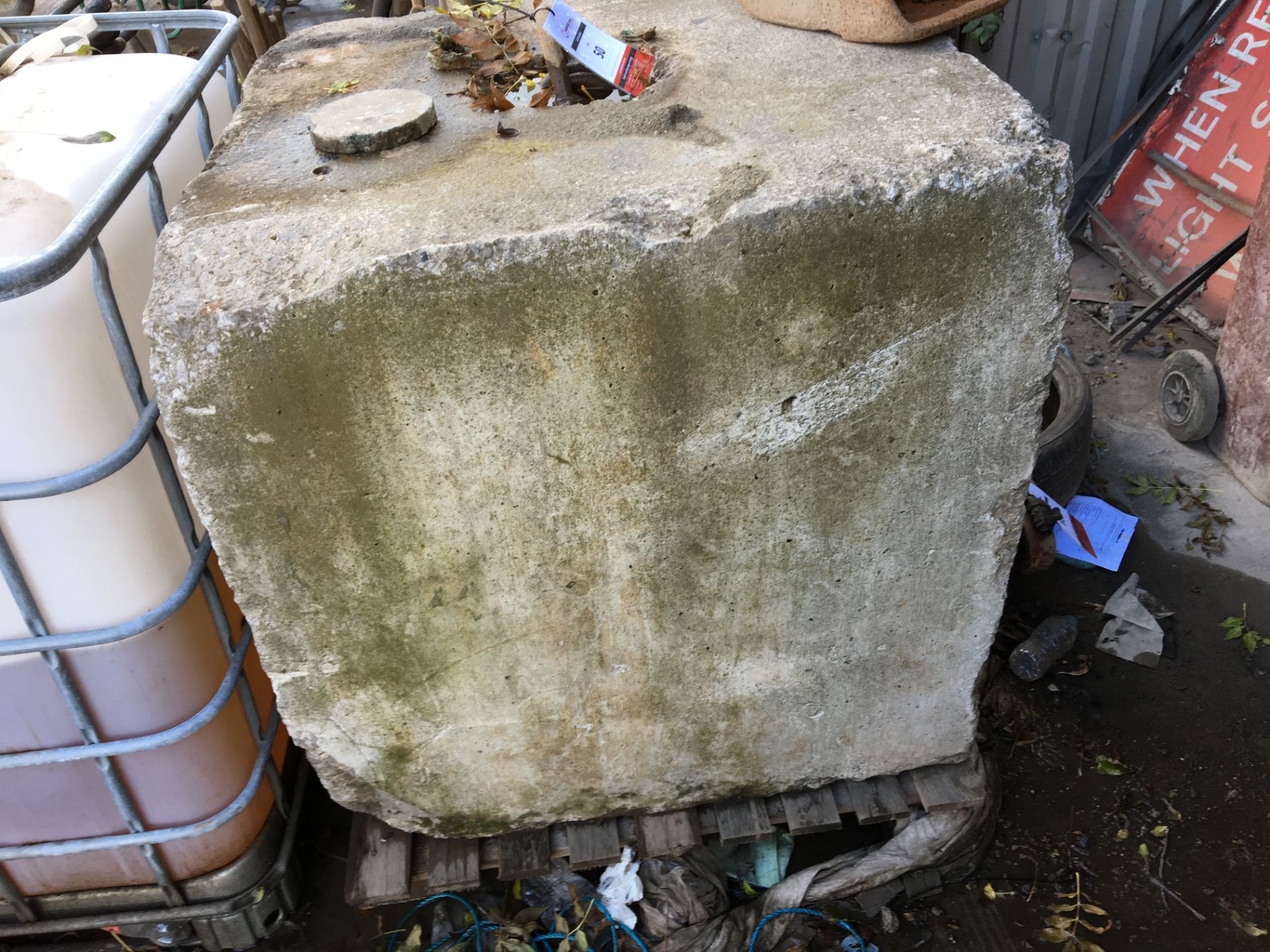 Large concrete block with metal lifting hook