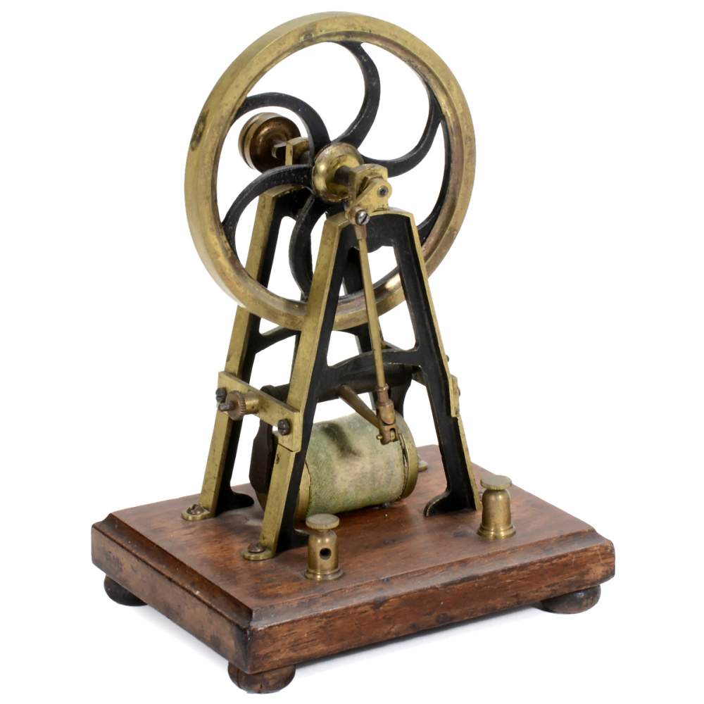 Electromagnetic Motor, c. 1880 Scientific brass electric motor, on mahogany board, wheel: Ø 4 in.,