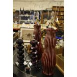 A pair of modern large red and white striped ceramic table lamps and another purple glass pair (4)