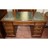 A Victorian mahogany pedestal desk with tooled writing surface and nine drawers