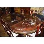 A Chinese dining table with mother-of-pearl floral inlay and a set of six chairs