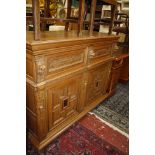 A Belgian oak cabinet with lion head detail, two drawers and two cupboards 147cm wide