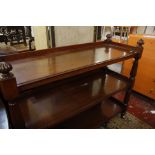 A Victorian mahogany three tier buffet with reeded turned supports 134cm wide