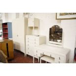 A white painted bedroom suite, 1920's, comprising: a chest of five drawers; two pot cupboards; one