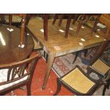 A rectangular mahogany table, circa 1900, with a crossbanded top on square tapering legs and spade