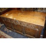 A 17th century and later oak and metal mounted coffer, the hinged top opening to a plain interior,