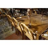 A long mahogany rectangular table, c1900, with a crossbanded top on square tapering legs and spade