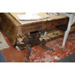 A George IV mahogany and crossbanded sofa table, circa 1825, the rectangular top with rounded