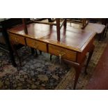 A George II style walnut writing table, mid 20th century, the leather lined moulded oblong top above