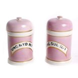 Four 19th Century pink pottery chemist jars with domed lids