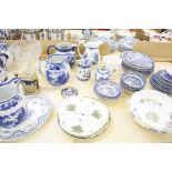 A quantity of blue and white, stoneware flagons, a clear glass butter dish, a glass pedestal