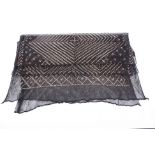 A 1920s Art Deco Egyptian assuit shawl, of black net with metallic hammered geometric design.