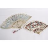 A late 19th century Chinese fan, with carved bone guards and pierced sticks, the feathers are