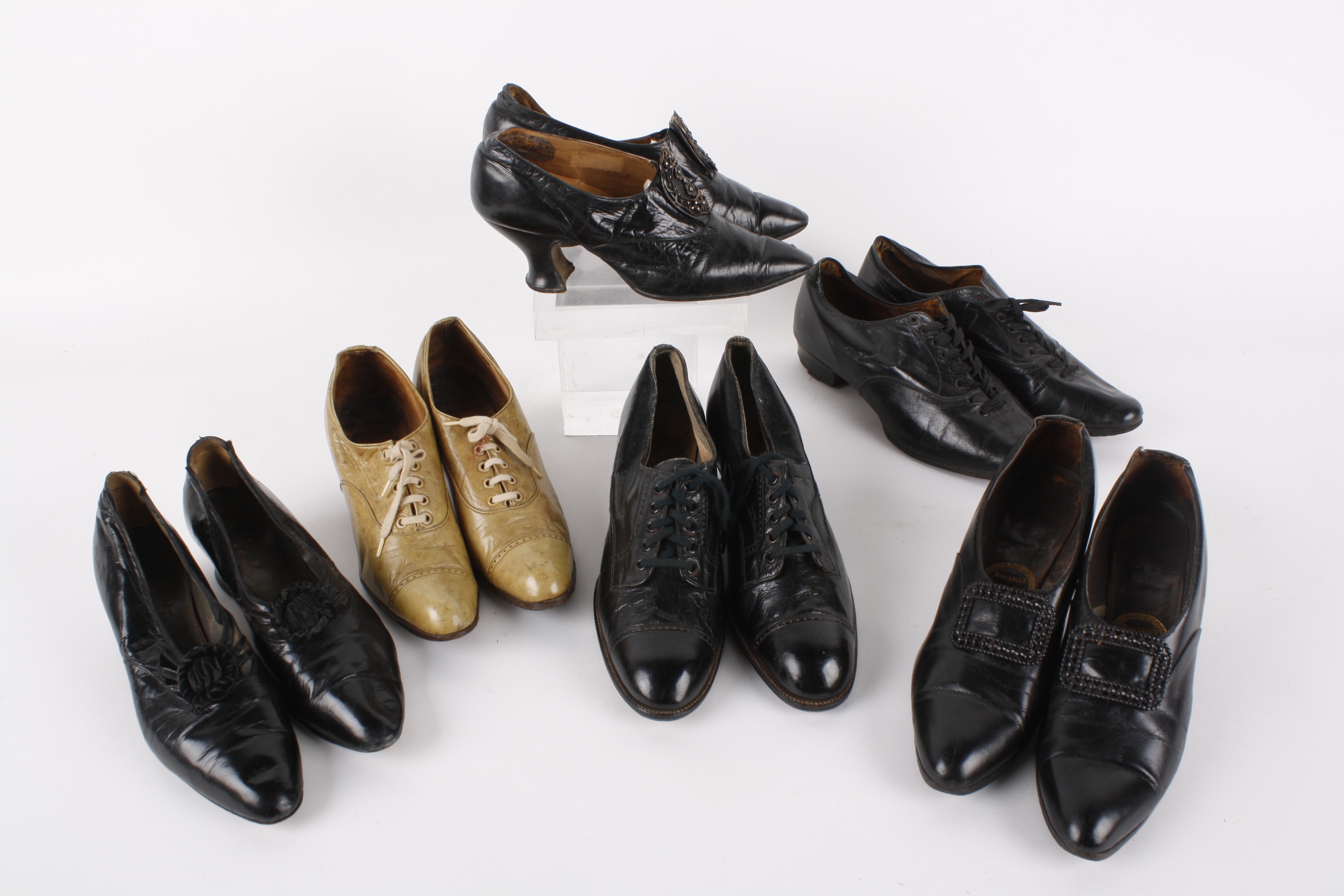 Six pairs of early 20th century ladies shoes, comprising: soft black leather shoes circa 1900 with