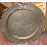An Indo-Persian large brass circular tray 91cm diameter and another smaller similar example