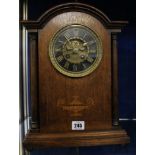 An early 20th Century oak inlaid mantel clock, 37cm high