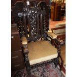 A Victorian carved oak armchair the back decorated with vine leaves
