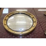 A Regency style convex mirror together with two oval gilt examples