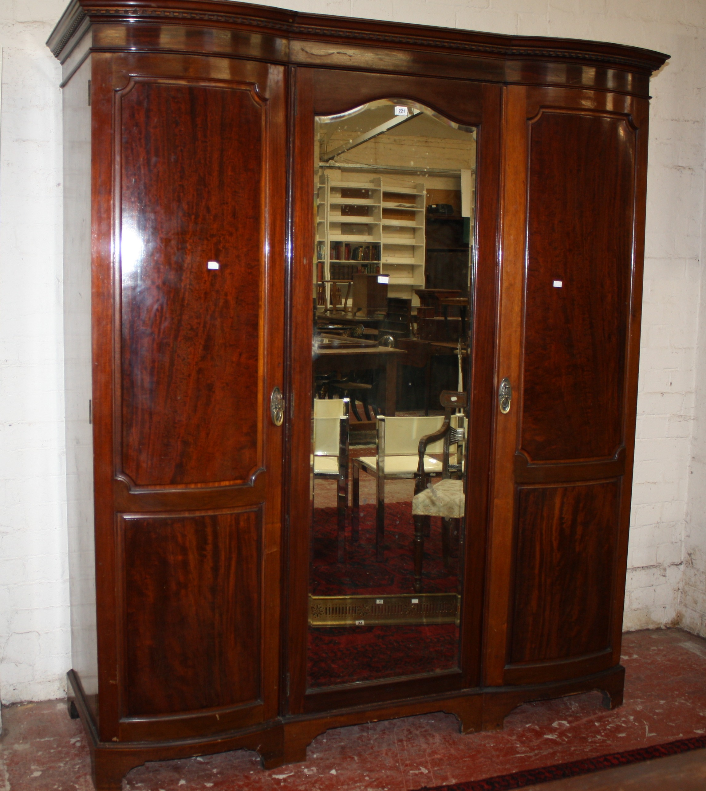 A late Victorian mahogany triple wardrobe with central mirror door 224cm high, 180cm wide