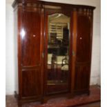 A late Victorian mahogany triple wardrobe with central mirror door 224cm high, 180cm wide