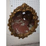 A Victorian style gilt decorated mirror 69 x 50cm and another circular example