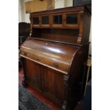 A Victorian mahogany roll top desk with superstructure, the desk opening to satinwood interior