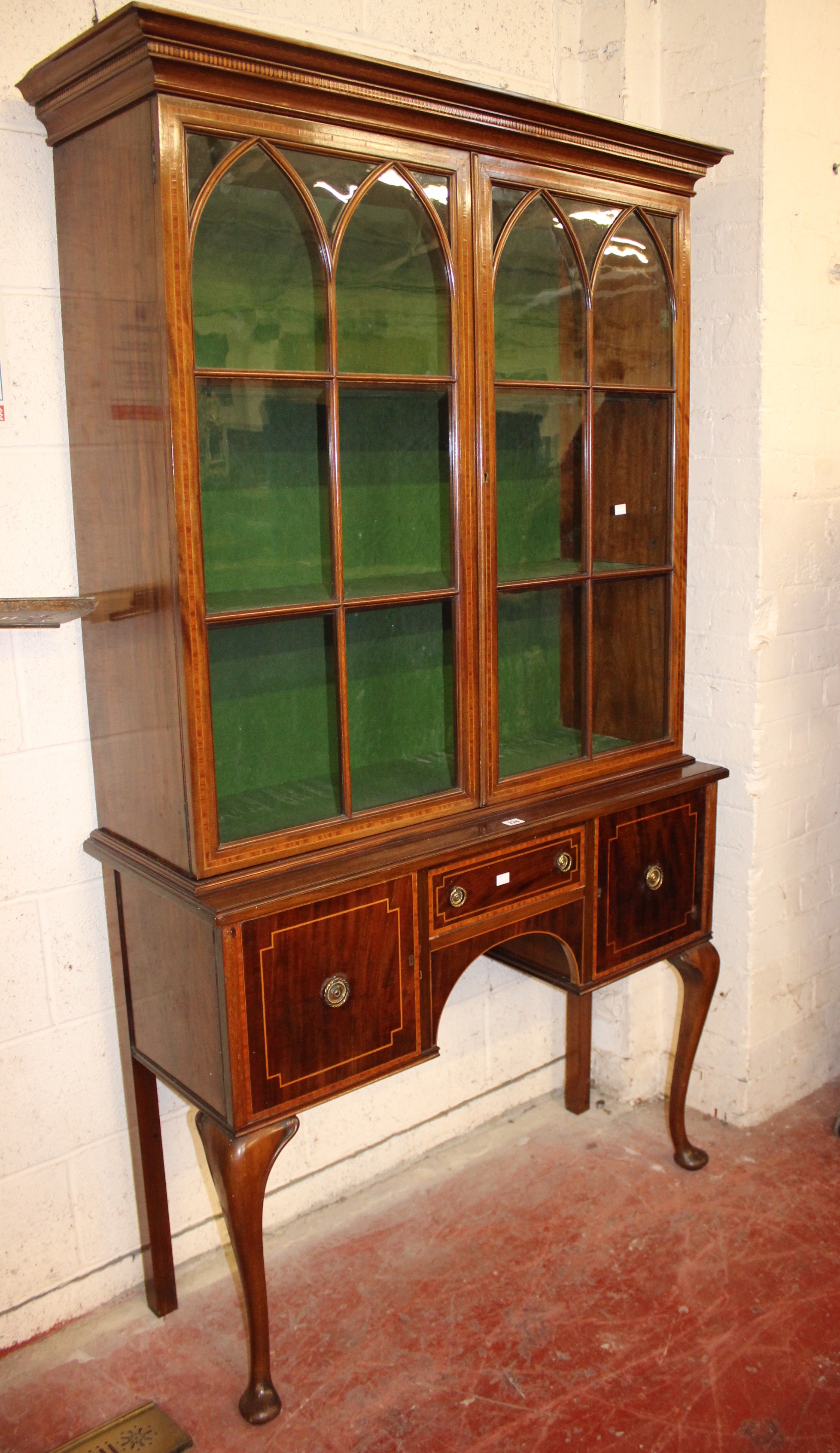 A mahogany and crossbanded display cabinet with glazed upper section and drawers and cupboards below