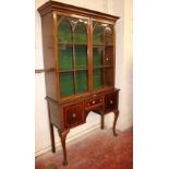 A mahogany and crossbanded display cabinet with glazed upper section and drawers and cupboards below