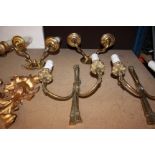 Two pairs of brass wall lights, together with two pairs of gilt metal wall lights.