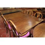 A 19th Century mahogany dining table with hinged leaves 161cm extended