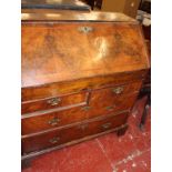 A George I walnut bureau with a sloping fall and two short and two long drawers 96cm wide